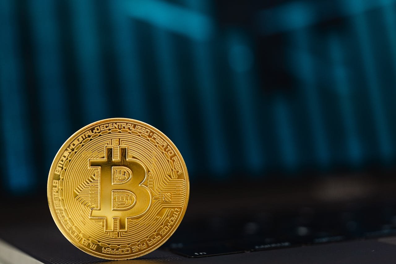hero-img Close-up of a golden Bitcoin coin on a computer keyboard symbolizing digital currency and blockchain technology.
